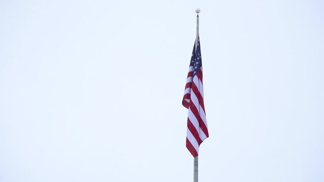 American Flag Waving Against Cloudy Sky