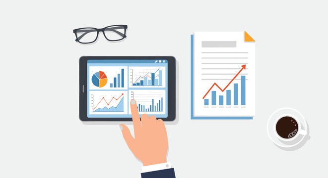 Top view of a businessman using a digital tablet to analyze colorful financial charts graphs and business reports on his desk.