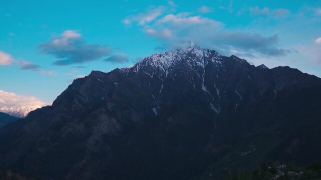 Landscape shot of snowy Himalayan mountain peak during the sunset as seen from Killar Town in Chamba district, Himachal Pradesh, India. Scenic natural Himalyan mountain background with copy space.