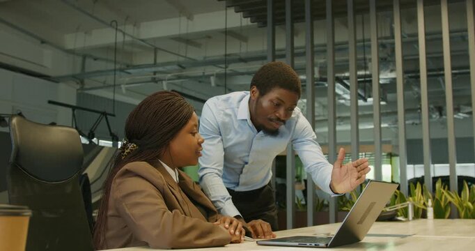 Sales professional instructs novice on software demonstration techniques
