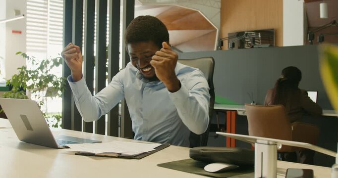 Group of colleagues expressing happiness following positive accomplishments