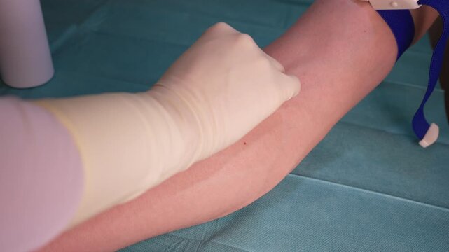 Medical Professional Disinfecting Patient's Arm for Blood Sample - Healthcare and Laboratory Concept