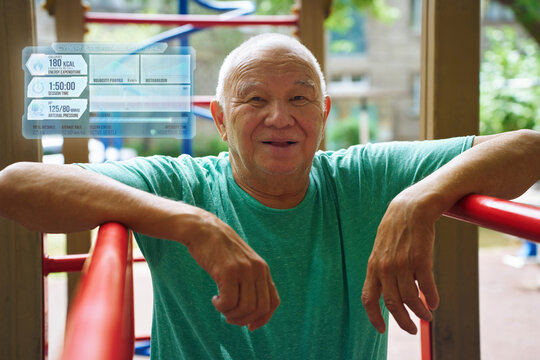 Man leaning on outdoor gym with fitness tracking hologram interface