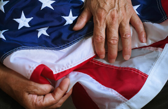 Hand touching and folding the American flag