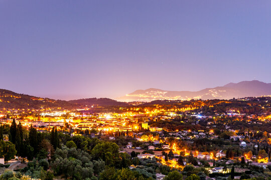 Illuminated cityscape of Grasse France at dusk
