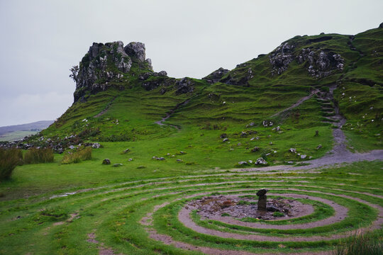 Celtic spiral labyrinth in the green Scottish Highlands countryside