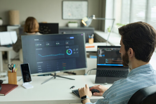 Analyst working on financial chart at office desk