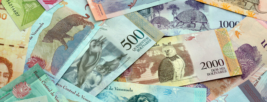 Venezuelan bolivar money banknotes pile on table. Venezuela bills of VES currency close up