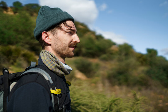 Hiker with backpack enjoying mountain landscape in Spain