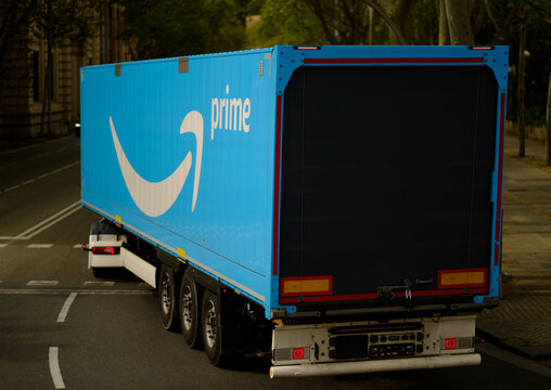 Large Blue Delivery Truck Driving Through City Street Representing Modern Worldwide Shipping Logistics and Parcel Distribution Company