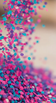 Scattered pink, purple, and turquoise confetti pieces creating a vibrant and festive abstract pattern, symbolizing celebration, joy, and party atmosphere