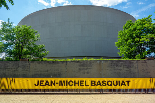 Washington, DC, April 27, 2026: Large yellow Jean-Michel Basquiat exhibit announcement banner outside the Smithsonian Hirshhorn Museum of Modern Art Washington DC