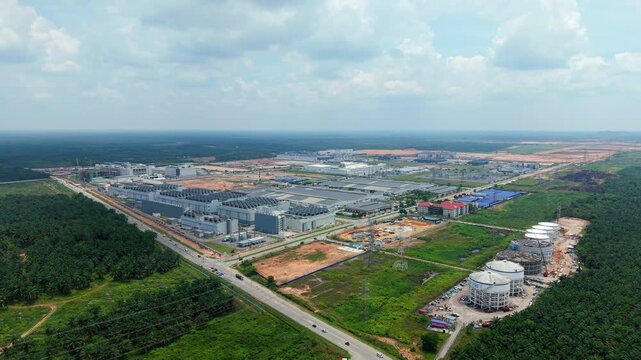 Aerial Orbit of Tech Park with Data Center, Storage Tanks Under Construction and Palm Plantation Framing, Malaysia