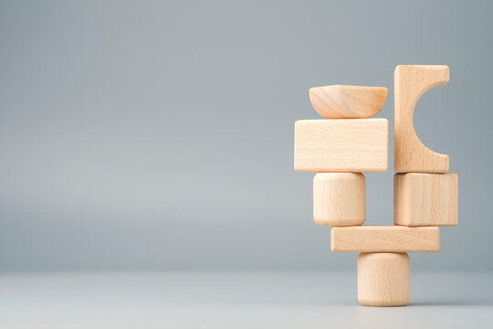 Single point of failure concept, wooden blocks stacked on one base representing system dependency, risk, stability, and creative thinking, idea development and balance