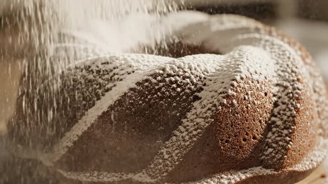 Bundt cake powdered sugar baking dessert sweet close up homemade brown texture soft swirl fresh delicious snack pastry treat perfect for celebration party holiday table ambiance