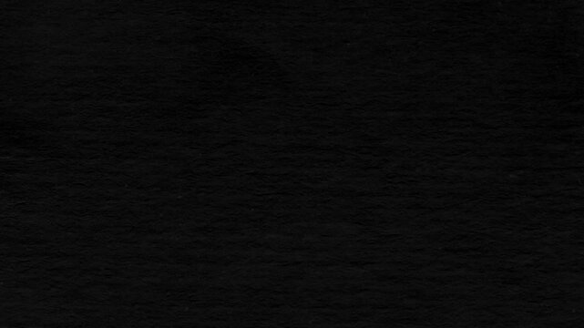 Seamless looping black crumpled paper background texture 4k resolution