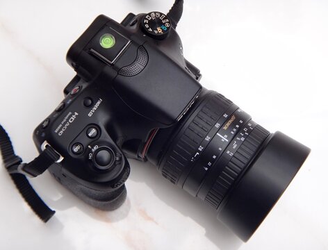 Professional digital camera with lens on white background