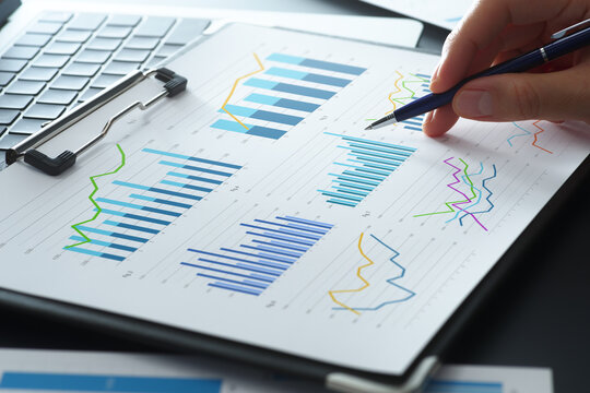 Business financial analysis reports with graphs. KPI performance data and results. Businessman reviewing plan and developing growth strategy on desk.