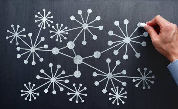 Knowledge graph. Visualization of semantic network structure. Organizing relationships between data and information. Consultant teaching how to draw diagram on blackboard.