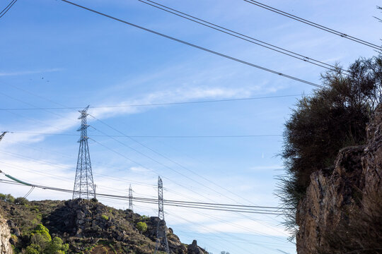 Power lines distributing electrical energy across mountainous landscape