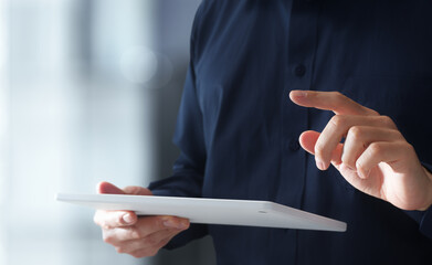 Man using tablet PC. Closeup of hands tapping on tablet screen. Smart mobile device and technology. © tadamichi