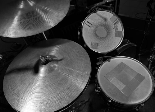 Dnepr, UKRAINE 09.27.2024 : Black and white high angle view of a professional drum kit stage setup. Featuring Sabian cymbals, snare drum, and tom-tom with dampening tape. 