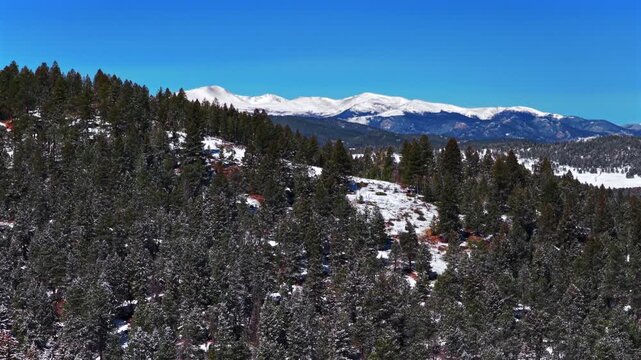 Snow-covered Blue Sky Mountain Evergreen Mount Blue Sky Front Range Rocky Mountains Colorado aerial drone springtime spring deep fresh powder snowfall sunny morning clear skies Mt Evans forward motion