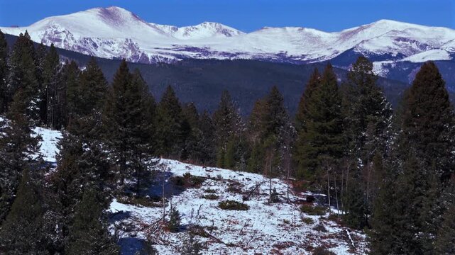 Snow-covered Blue Sky Mountain Evergreen Mount Blue Sky Front Range Rocky Mountains Colorado aerial drone springtime spring deep fresh powder snowfall sunny morning clear skies Mt Evans forward pan up