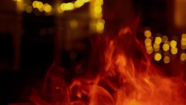 Cinematic 4K vertical shot of intense, roaring fire pit flames isolated against a pure black background. Perfect for social media formats and VFX blending modes.