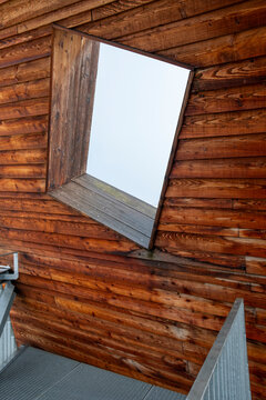 Rustic brown wood cabin exterior showing facade texture pattern and window with simple architecture detail in natural material design