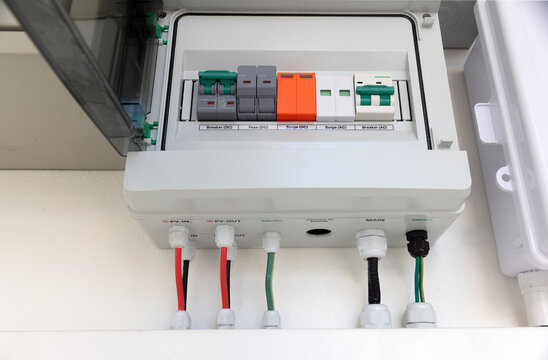 Solar Combiner Box on a House Wall with Integrated DC and AC Safety Components (Breakers, Fuses, Surge Protection) for a Hybrid PV System.