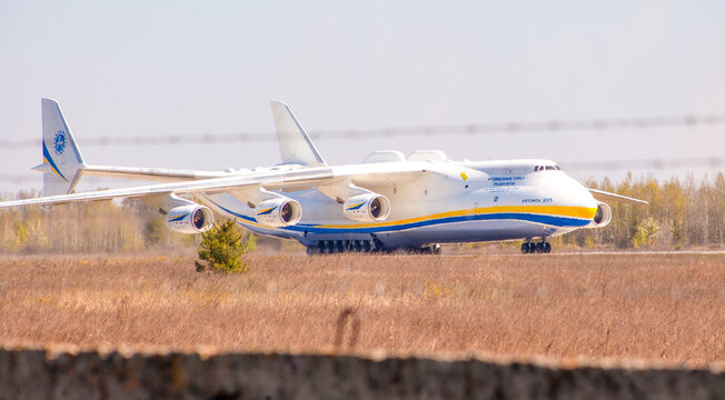 Plane Antonov AN-225 Mriya biggest airplane in the world. UR-82060 aircraft Air cargo land strip landing gear wheels. Airport runway. Hostomel, Ukraine - April 23, 2020