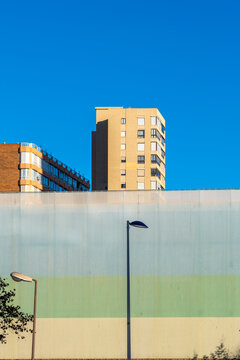 Graphic minimal geometry on a building wall facade leaves wide sky space with a flag detail in Benidorm Alicante Valencian Spain