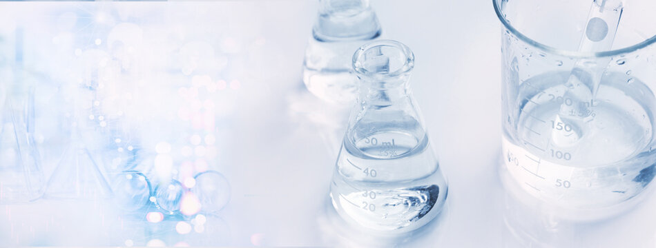 water in glass flask and beaker in chemistry science laboratory banner  background