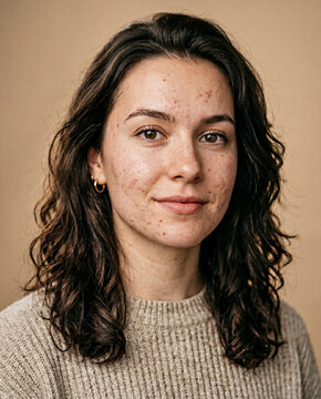 Close-up portrait of a young woman with natural skin imperfections and gray card reference, slightly underexposed, suitable for retouching and color grading practice.