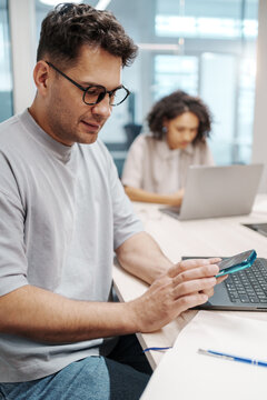 Business Owner Reviews Budget Details. Accountant Analyzing Receipts And Notebooks Beside Computer Equipment
