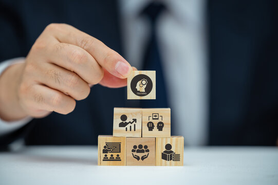 Human resource training and development concept.Business, personal development improving and enhancing competency, performance..Putting wooden cubes training with brainstorm, coaching, learning icons.