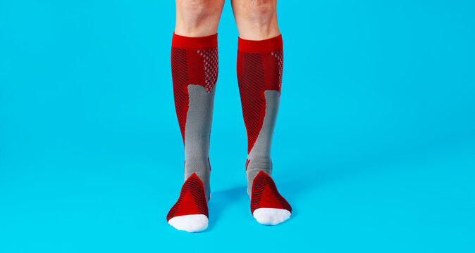 man wearing red compression socks, banner format