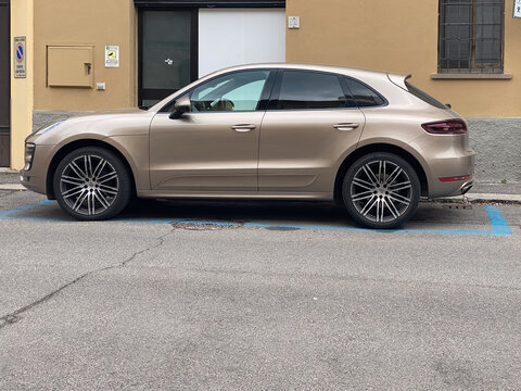 Porsche Macan SUV parked on a city street, showcasing luxury crossover design and high end automotive engineering