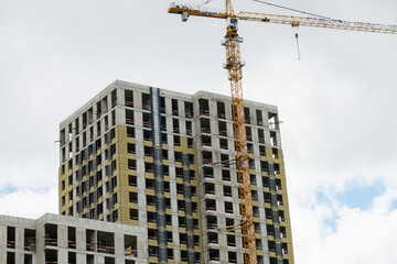Fototapeta premium Residential building under construction with crane