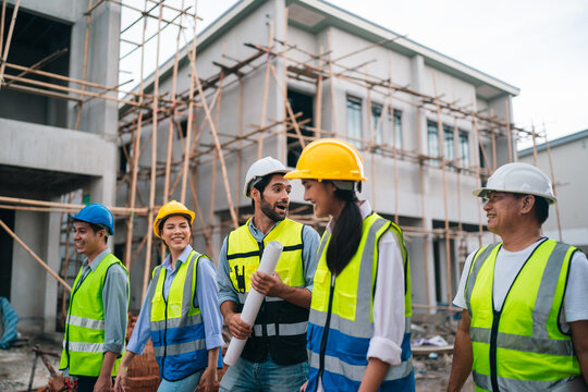 Construction worker group building site safety helmet safety vest scaffolding planning teamwork engineer architect inspection