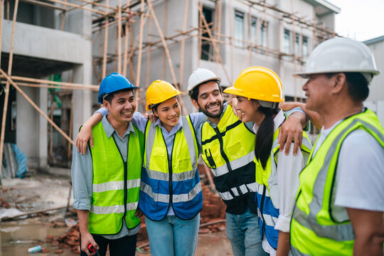 Construction worker group in hard hat and safety vest at building site, teamwork and happy collaboration