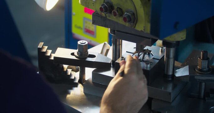 Close-up of metal stamping die in punch press during operation, sheet metal forming process in industrial production