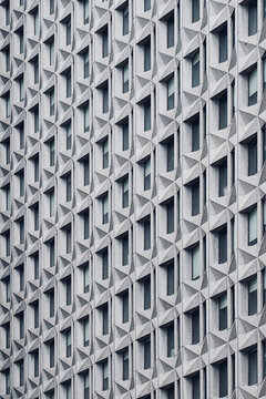 Concrete relief pattern on architecture facade with modern abstract geometry repetition texture creating a tactile building exterior detail