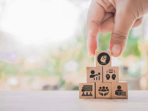 Human resource training and development concept.Business, personal development improving and enhancing competency, performance..Putting wooden cubes training with brainstorm, coaching, learning icons.