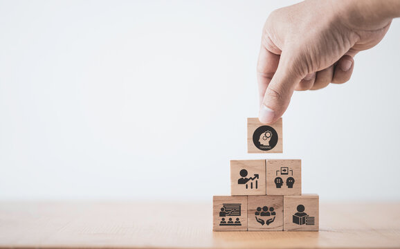 Human resource training and development concept.Business, personal development improving and enhancing competency, performance..Putting wooden cubes training with brainstorm, coaching, learning icons.