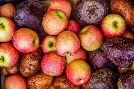 Assortment of fresh fruit and veg together apples beets and potatoes