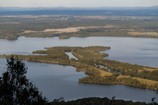 High view of river reach flowing into lake on a sunny day