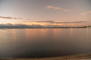 Fototapeta premium Dramatic sunset landscape over the Puerto Princesa harbor