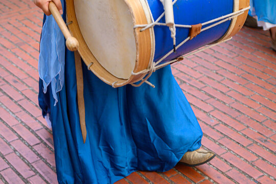 Musician with a large blue drum at a street festival The Concept of celebration
